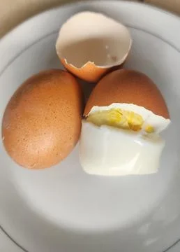 Boiled eggs with their shells peeled, ready for breakfast Stock Photos