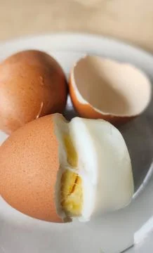 Boiled eggs with their shells peeled, ready for breakfast Stock Photos