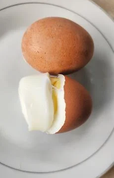 Boiled eggs with their shells peeled, ready for breakfast Stock Photos