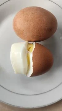 Boiled eggs with their shells peeled, ready for breakfast Stock Photos