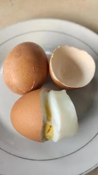 Boiled eggs with their shells peeled, ready for breakfast Stock Photos