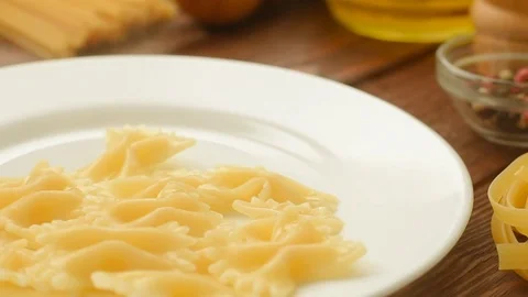 Boiled farfalle on the pasta spoon Stock Footage 72976944