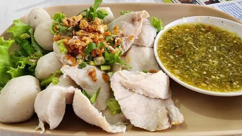 Boiled Fish Fillets and Fish Balls served with Spicy Green Seafood Dipping. Stock Photos