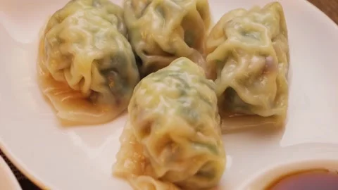 Boiled Gyoza dumplings stuffing with minced pork and vegetables close up footage Stock Footage 308563443