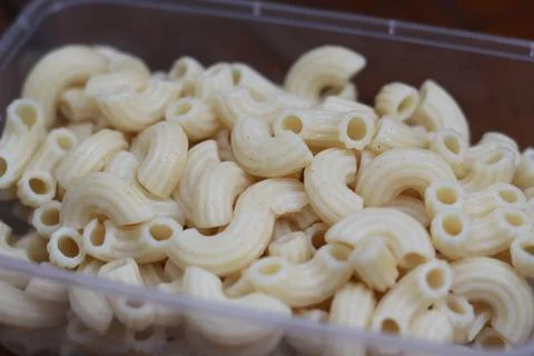 Boiled macaroni in a transparent container Stock Photos