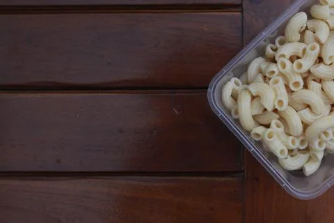 Boiled macaroni in a transparent container Stock Photos