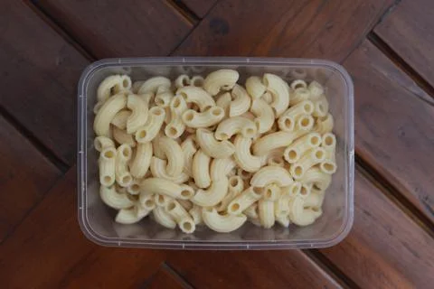 Boiled macaroni in a transparent container Stock Photos