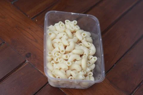 Boiled macaroni in a transparent container Stock Photos