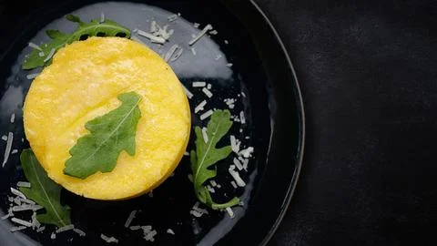 Boiled mashed potatoes in a dark plate Stock Photos