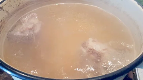 Boiled meat broth in a saucepan Stock Footage 102821919