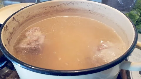 Boiled meat broth in a saucepan Stock Footage 102821923