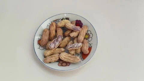 Boiled peanuts served on a plate against a white background. Stock Footage 324610430