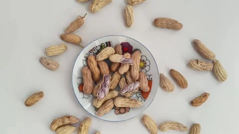 Boiled peanuts served on a plate against. peanuts on a white background. Stock Footage 324610446