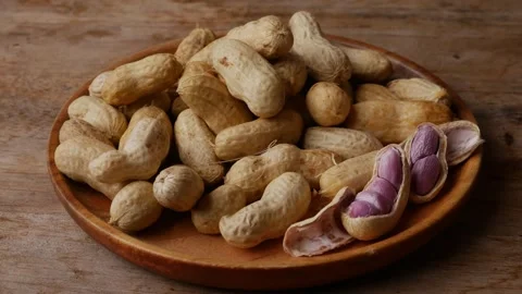 Boiled peanuts in shell with purple violet skin kernels revealed Видео 331494043