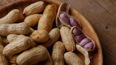 Boiled peanuts in shell with purple violet skin kernels revealed Видео 331901015