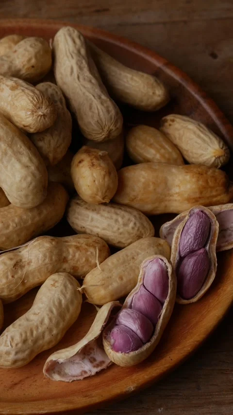 Boiled peanuts in shell with purple violet skin kernels revealed Stock Footage 332831366