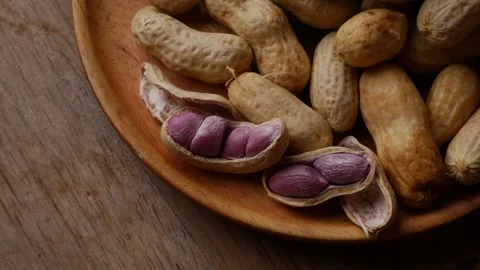 Boiled peanuts in shell with purple violet skin kernels revealed 스톡 동영상 333834050