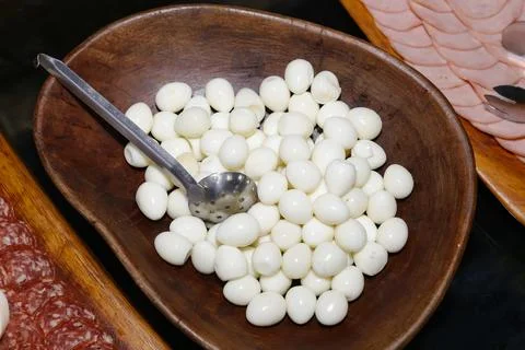 Boiled peeled quail eggs in rustic wooden bowl Stock Photos