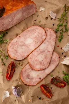 Boiled pork with herbs and tomatoes on craft paper Stock Photos