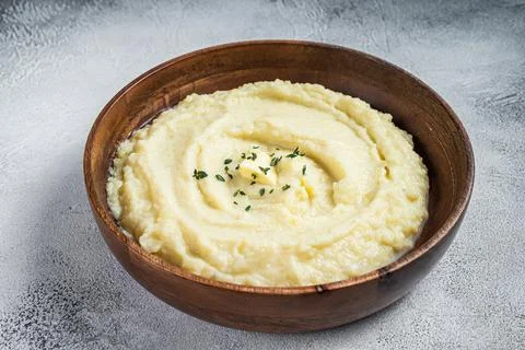 Boiled potato puree, Mashed potatoes in a wooden plate. White background. Top Stock Photos