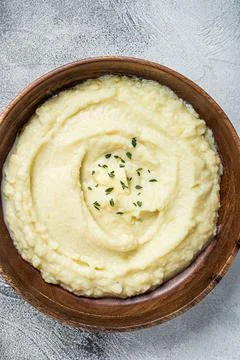 Boiled potato puree, Mashed potatoes in a wooden plate. White background. Top Stock Photos