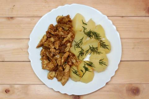 Boiled potatoes and chicken in Thai on wooden background Stock Photos