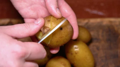 Boiled potatoes clean by hand. High quality 4k footage Stock Footage 255598349