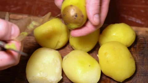 Boiled potatoes clean by hand. High quality 4k footage Stock Footage 255598529