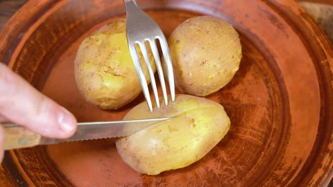 Boiled potatoes cut in a plate Stock Footage 255039336