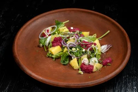 Boiled potatoes with dill and beetroot paste. Sprinkled with onions and capers. 스톡 사진