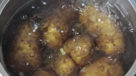 Boiled potatoes in a peel in a pot with boiling water Stock Footage 130621660