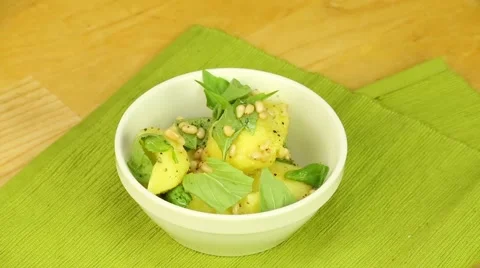 Boiled potatoes with pine nuts and basil Stock Footage 58493599