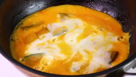 Boiled pumpkin with egg in a frying pan, rotating Stock Footage 322951449