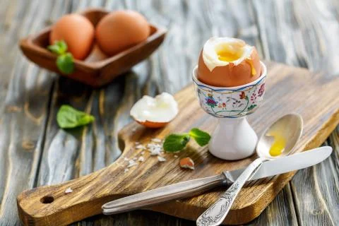 Boiled soft-boiled egg in the stand. Stock Photos