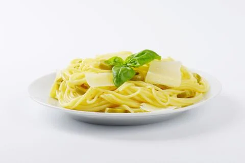 Boiled spaghetti with parmesan cheese, green olives and fresh basil Stock Photos