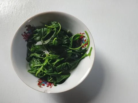 Boiled Spinach in Ceramic Bowl with Copy Space on White Background Stock Photos