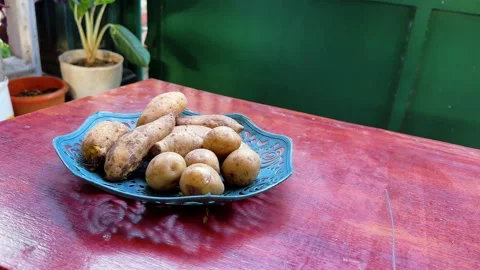 Boiled sweet potatoes served on a decorative plate on a wooden table Stock Footage 340050064