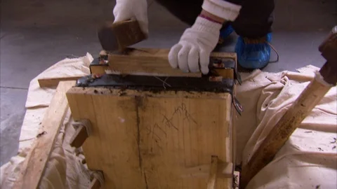 Boiled tea leaves being packed in wooden box Stockbeeldmateriaal 88546528