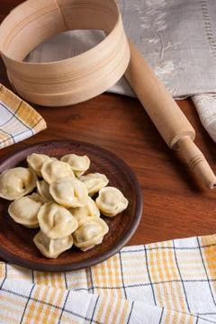 Boiled Ukrainian meat dumplings or ravioli on wooden background. Stock Photos