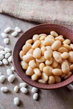 Boiled white kidney beans in a rustic bowl Stock Photos