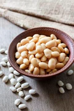 Boiled white kidney beans in a rustic bowl Stock Photos