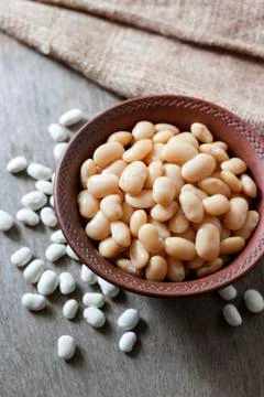 Boiled white kidney beans in a rustic bowl Stock Photos