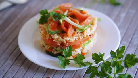 Boiled white rice with salted red fish, cucumbers and other vegetables Stock Footage 252091802