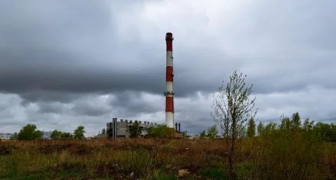 Boiler room with a high pipe backdrop of rain clouds 스톡 사진