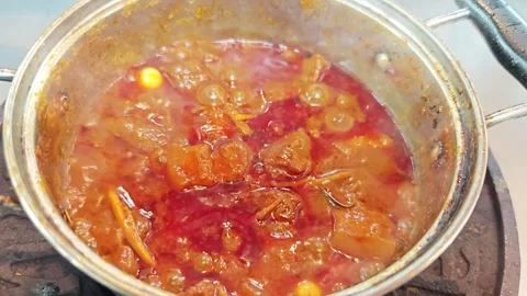 Boiling and bubbling Northern Thai pork curry Kaeng Hang Le inside a pot. Stock Footage 343224487