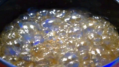 Boiling and bubbling sugar syrup making caramel Stock Footage 113190818