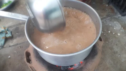 Boiling aromatic tea in a traditional ketli over flame Stock Footage 270285973
