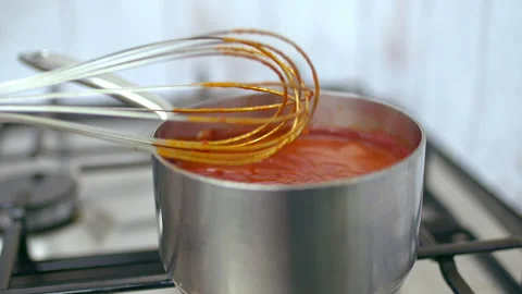Boiling barbecue sauce with different ingredients, spices in a bowl in 4K. Stock Footage 135993200