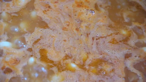 Boiling bean soup close-up. Stir the soup with a spoon Stock Footage 133537811