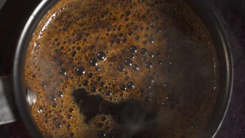 Boiling black coffee. Closeup Stock Footage 99730579